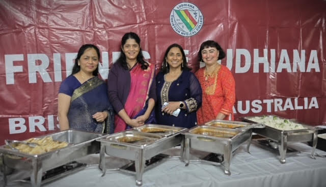 Volunteers standing in front of the Friends of Ludhiana Australia banner