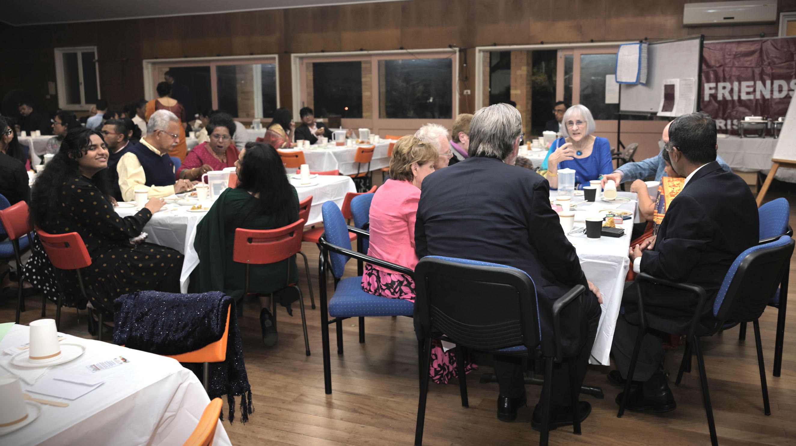 Guests seated at tables during the fellowship dinner