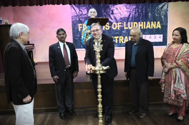 A guest lighting the lamp during the opening ceremony